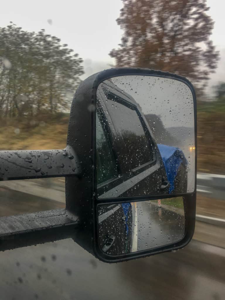 truck mirror in the rain while moving