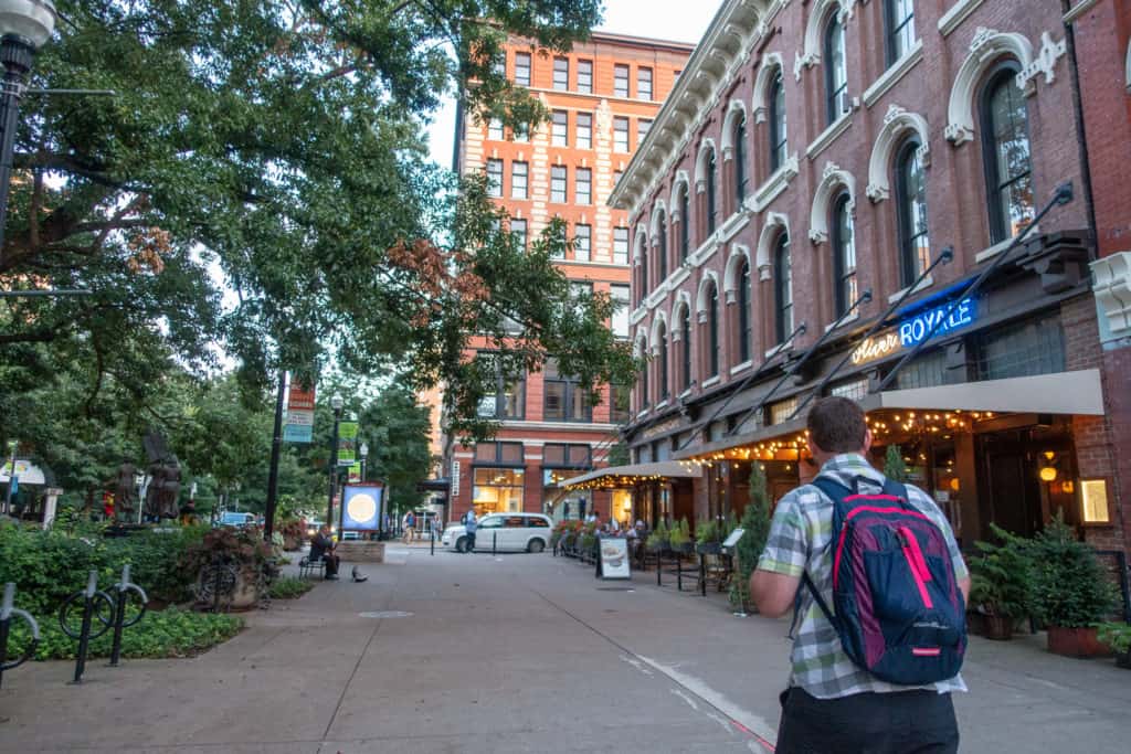 best-things-to-do-in-knoxville Barrett walking by the Oliver hotel in Knoxville, Tennessee, one of the best places to stay in downtown Knoxville.