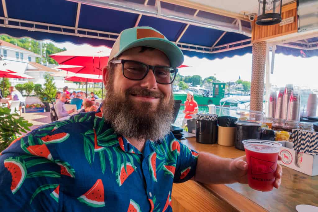 how-to-get-to-mackinac-island Barrett enjoying a drink on the Pink Pony Patio on Mackinac Island