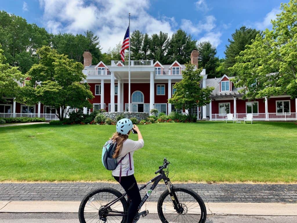 Cindy taking a picture while on her bike of the Inn at Black Star Farms