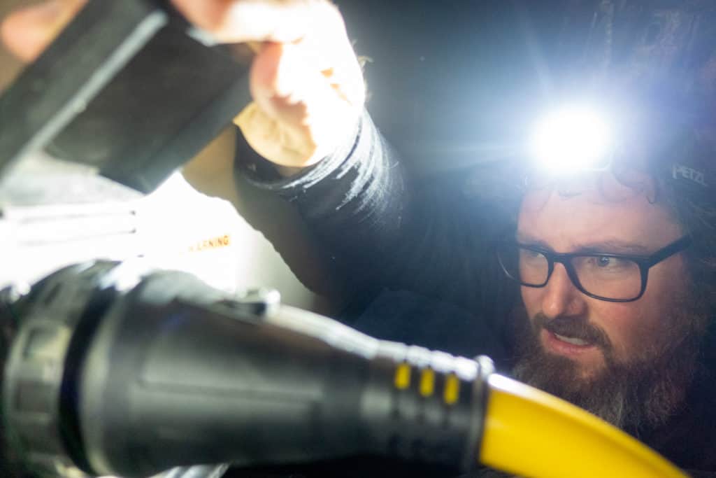 Barrett using his headlamp while messing with our RV power cord