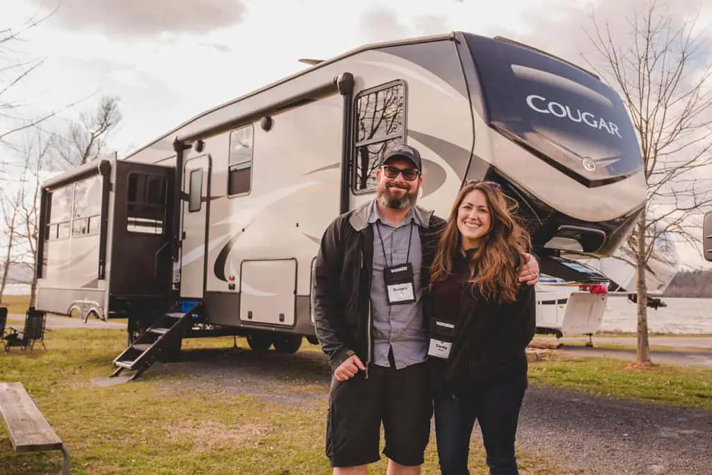 cindy and barrett in front of their keystone cougar fifth wheel