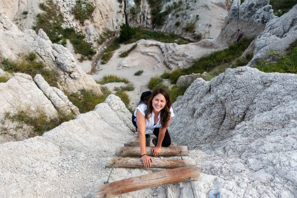 Cindy climbing a ladder in Badlands National Park