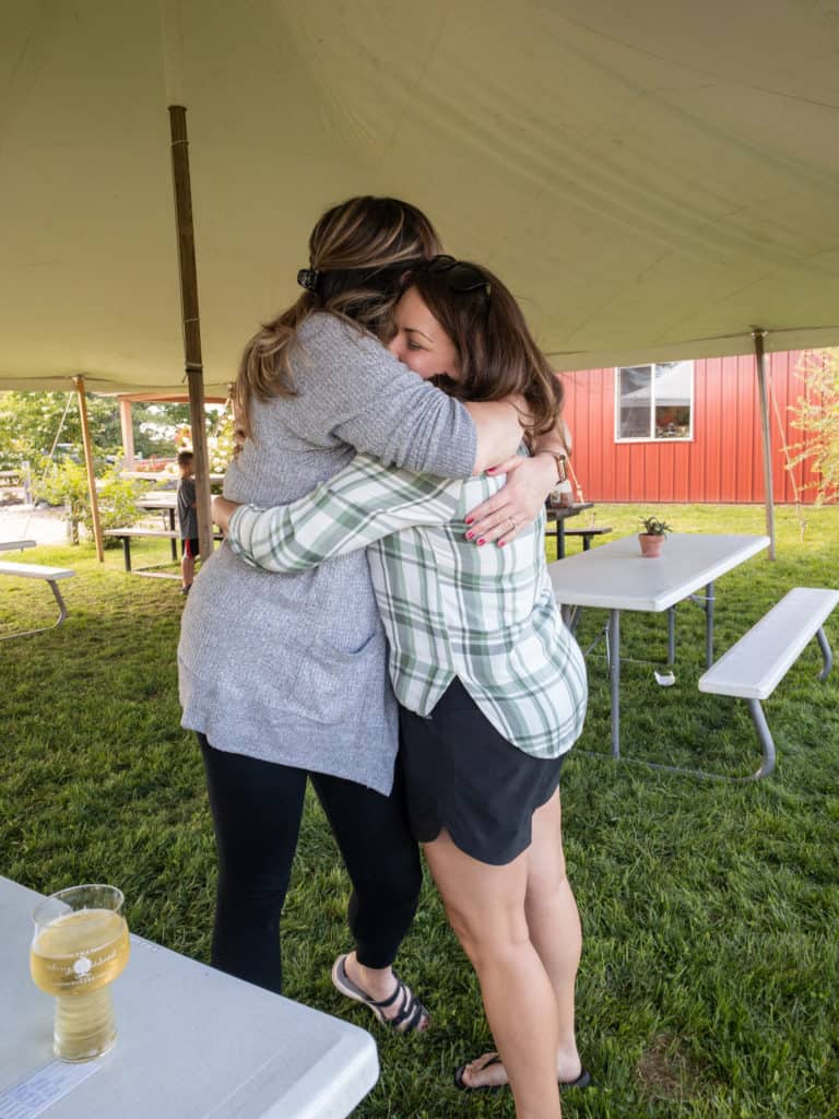 Enjoying cider and hugs with friends in Michigan while full-time RV living