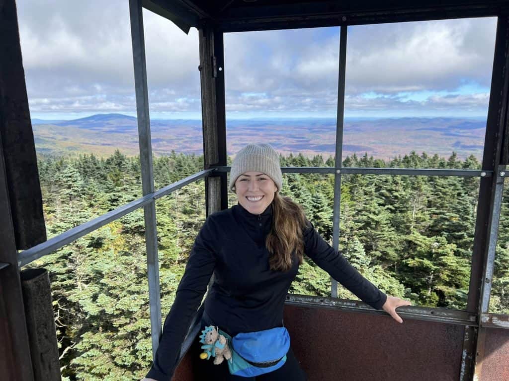Cindy in a fire tower wearing her Midlayer on Appalachian Trail Gear List