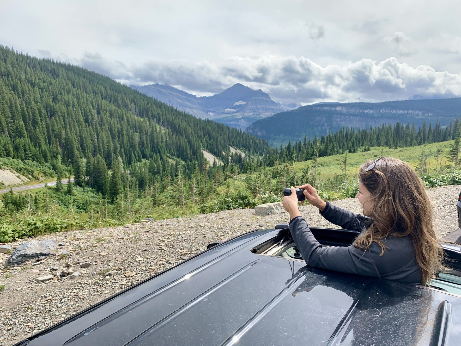 Glacier National Park Itinerary Taking a picture on Going-to-the-Sun Road