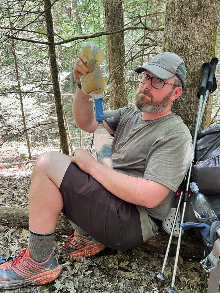 appalachian trail hike Barrett filtering water on the AT